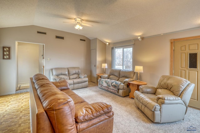 living area with visible vents, a textured ceiling, and vaulted ceiling