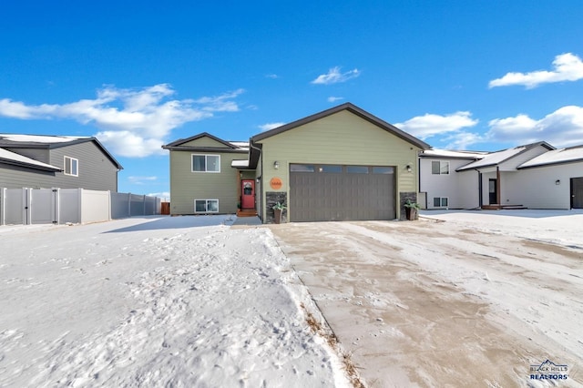 single story home with a garage and fence