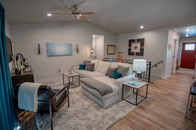 living area with baseboards, lofted ceiling, recessed lighting, light wood-style flooring, and a ceiling fan