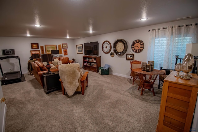 carpeted living area with visible vents, recessed lighting, and baseboards