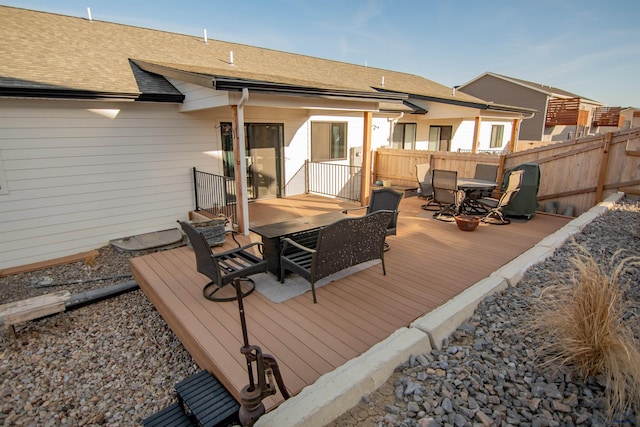 wooden terrace featuring outdoor dining area and fence