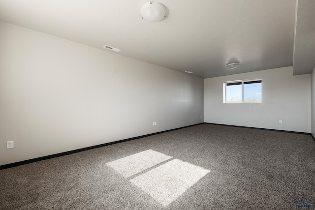 carpeted empty room with visible vents and baseboards