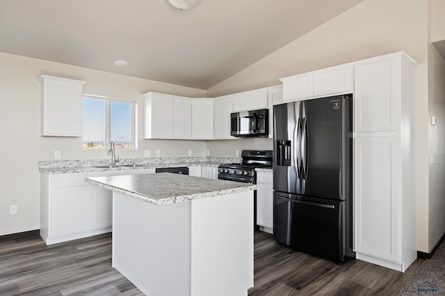 kitchen with a kitchen island, dark wood-type flooring, vaulted ceiling, appliances with stainless steel finishes, and white cabinets