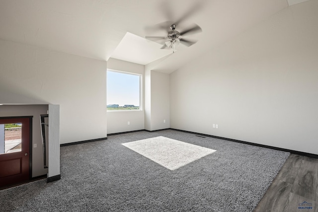 unfurnished living room with baseboards, lofted ceiling, and ceiling fan