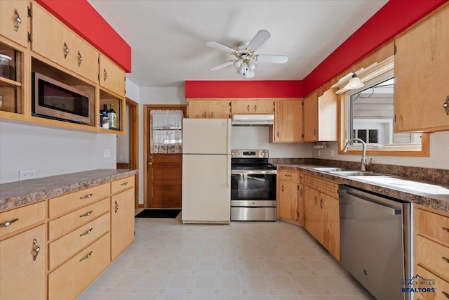 kitchen featuring light brown cabinets, ceiling fan, under cabinet range hood, stainless steel appliances, and a sink