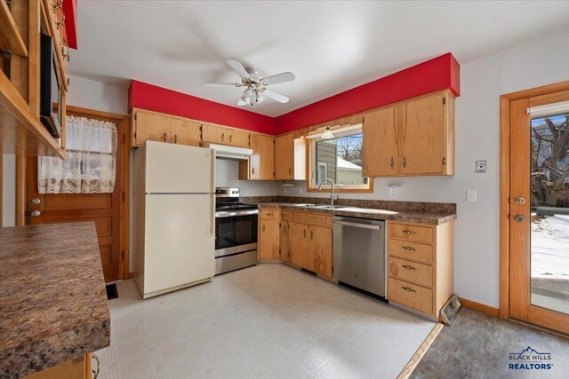 kitchen with a sink, under cabinet range hood, dark countertops, appliances with stainless steel finishes, and ceiling fan