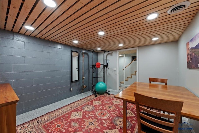 exercise room featuring recessed lighting, visible vents, wooden ceiling, and concrete block wall