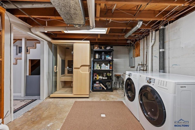 clothes washing area with washing machine and clothes dryer, laundry area, and electric panel