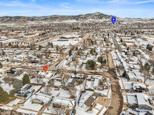 snowy aerial view with a residential view