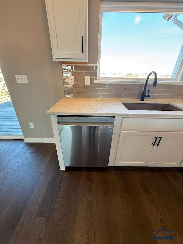 kitchen with white cabinetry, dark wood finished floors, a sink, dishwasher, and tasteful backsplash