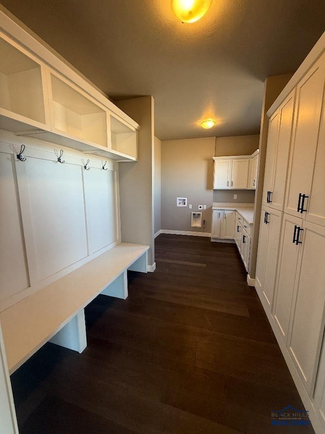 mudroom with baseboards, a textured ceiling, and dark wood-style flooring