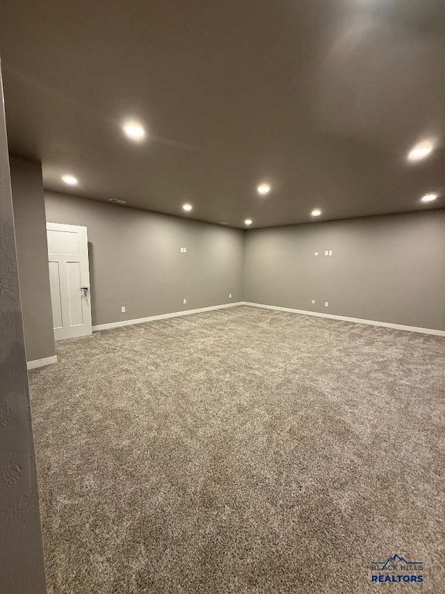 basement featuring carpet flooring, recessed lighting, and baseboards