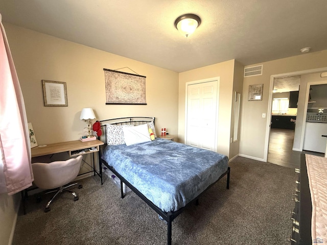 carpeted bedroom featuring visible vents and baseboards