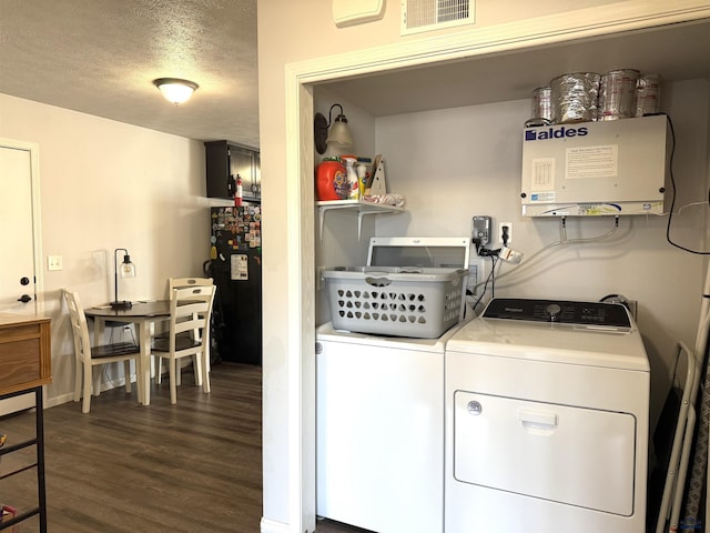 laundry room featuring visible vents, dark wood finished floors, laundry area, separate washer and dryer, and a textured ceiling