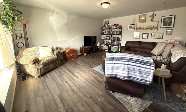 living room with visible vents and wood finished floors