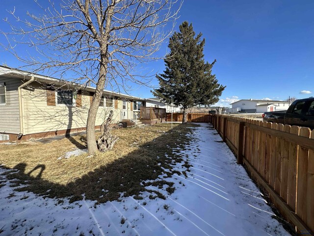 yard layered in snow with fence