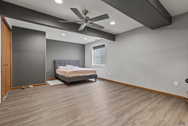 unfurnished bedroom featuring beam ceiling, a ceiling fan, wood finished floors, recessed lighting, and baseboards