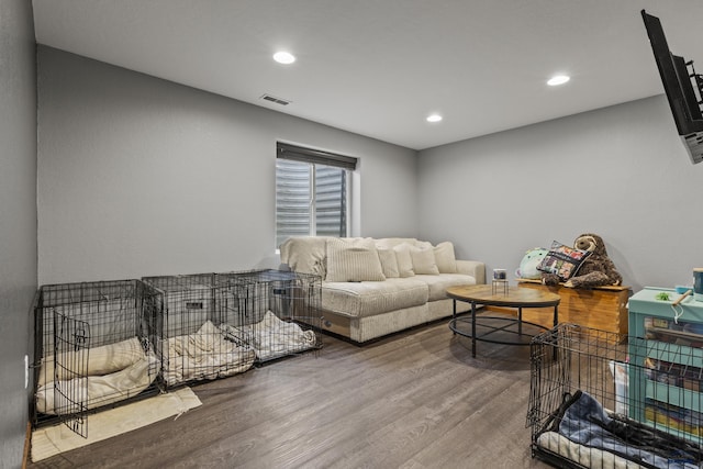 living area featuring recessed lighting, visible vents, and wood finished floors