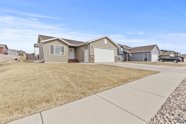 single story home featuring a front lawn, driveway, a trampoline, a residential view, and an attached garage