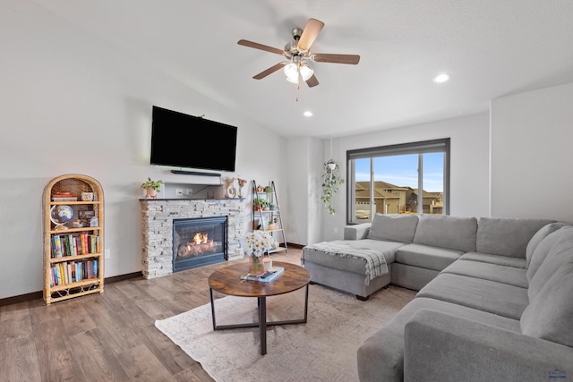 living area with baseboards, recessed lighting, a fireplace, wood finished floors, and a ceiling fan