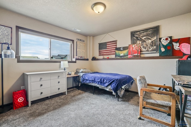 carpeted bedroom featuring visible vents and a textured ceiling