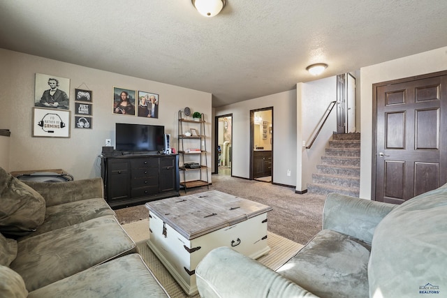 living area featuring light colored carpet, a textured ceiling, stairs, and baseboards