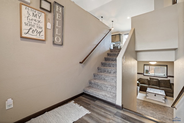 stairs with baseboards and wood finished floors