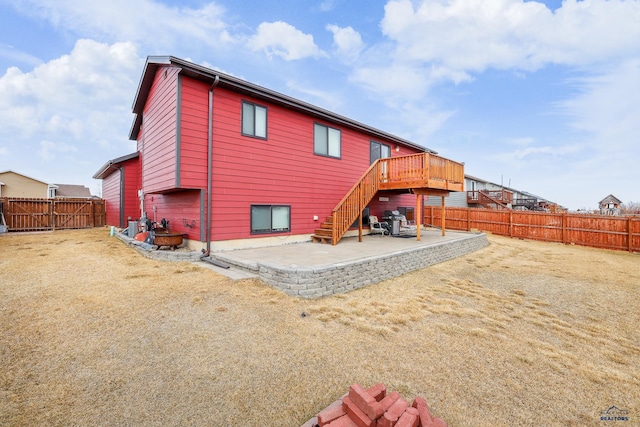 back of property featuring stairway, a patio area, and a fenced backyard