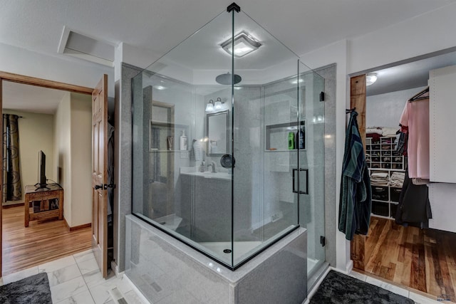 2204 Cruz Dr, Rapid City, SD 57702 - full bath with a spacious closet, baseboards, a stall shower, and marble finish floor