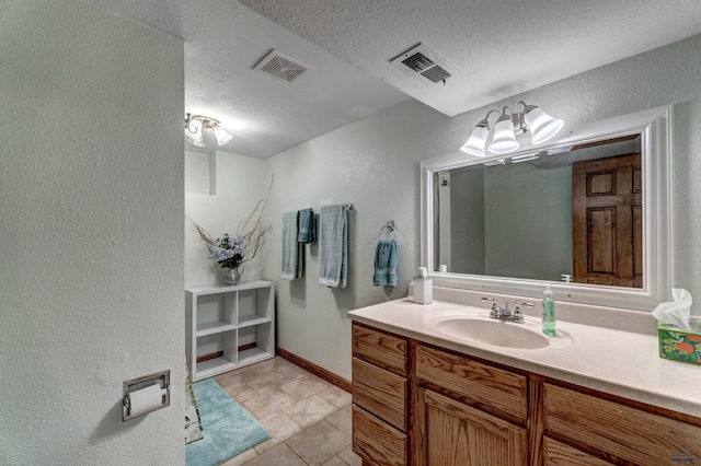 2204 Cruz Dr, Rapid City, SD 57702 - bathroom featuring tile patterned flooring, vanity, visible vents, and a textured ceiling