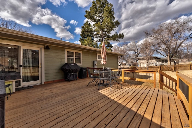 2204 Cruz Dr, Rapid City, SD 57702 - deck featuring grilling area, outdoor dining space, and fence