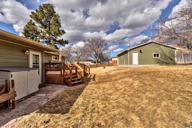 2204 Cruz Dr, Rapid City, SD 57702 - view of yard featuring a wooden deck, an outdoor structure, and fence