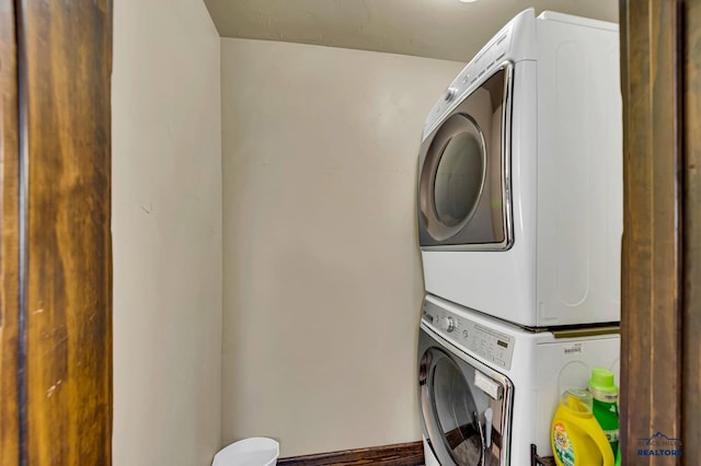 washroom featuring stacked washer / dryer