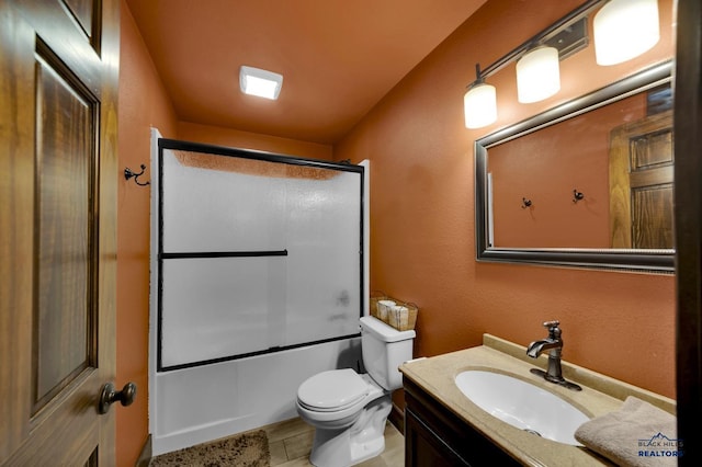 bathroom with enclosed tub / shower combo, toilet, and vanity
