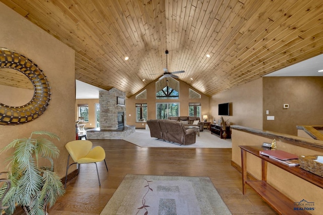 living room featuring ceiling fan, wood finished floors, wood ceiling, and high vaulted ceiling