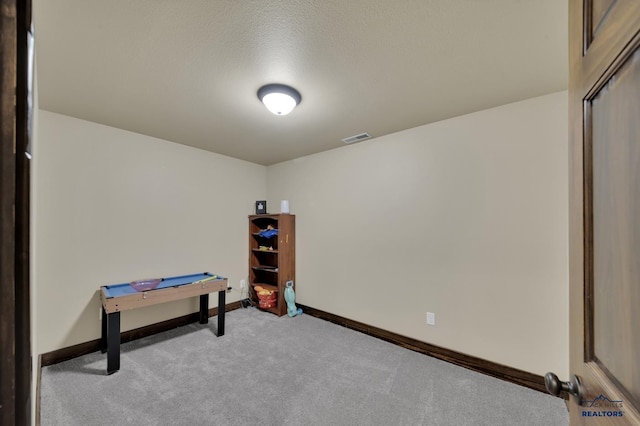rec room featuring visible vents, baseboards, a textured ceiling, and carpet flooring
