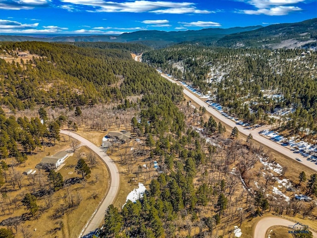 drone / aerial view with a mountain view and a view of trees