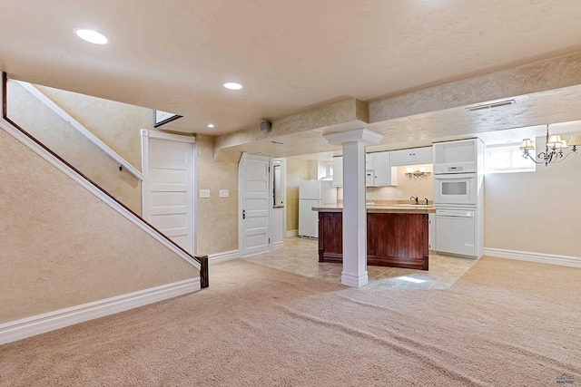 1120 W Blvd, Rapid City, SD 57701 - kitchen featuring visible vents, light carpet, white appliances, white cabinets, and light countertops