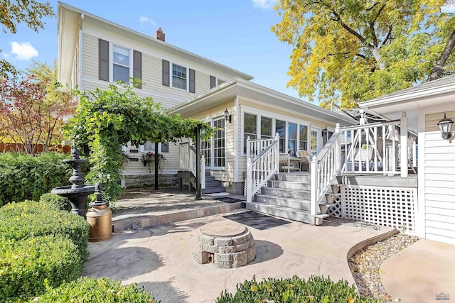 1120 W Blvd, Rapid City, SD 57701 - exterior space with a patio area, an outdoor fire pit, a chimney, and a deck