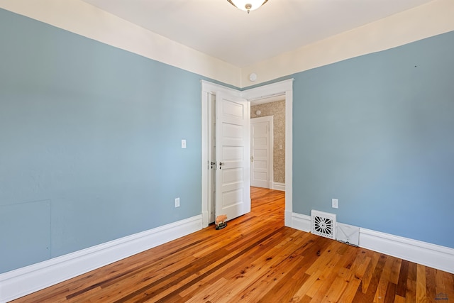 1120 W Blvd, Rapid City, SD 57701 - unfurnished room featuring visible vents, baseboards, and hardwood / wood-style flooring