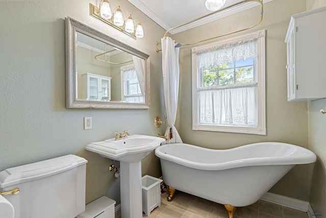1120 W Blvd, Rapid City, SD 57701 - bathroom with a shower with shower curtain, a freestanding tub, ornamental molding, tile patterned flooring, and toilet