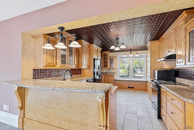 1120 W Blvd, Rapid City, SD 57701 - kitchen featuring an ornate ceiling, under cabinet range hood, a peninsula, stainless steel refrigerator with ice dispenser, and black electric range oven