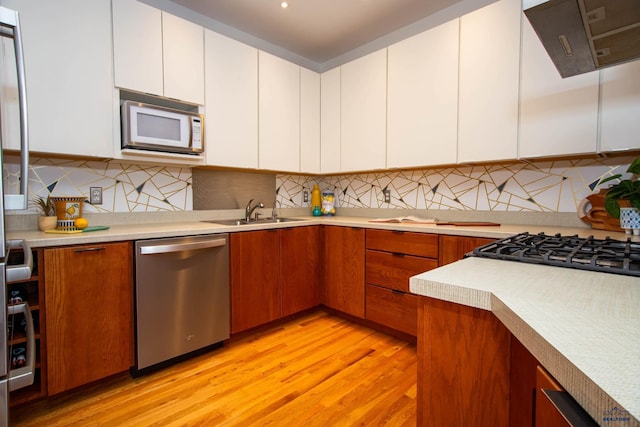 1515 Forest Dr, Rapid City, SD 57701 - kitchen featuring white microwave, a sink, light countertops, and stainless steel dishwasher