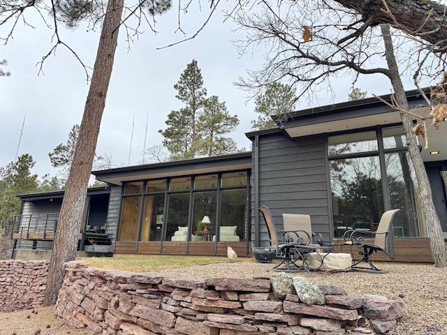 1515 Forest Dr, Rapid City, SD 57701 - rear view of house featuring a sunroom