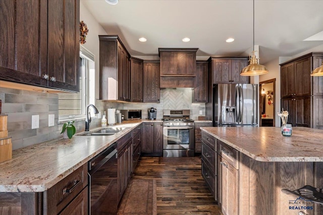 kitchen featuring dark brown cabinetry, dark wood-style flooring, appliances with stainless steel finishes, and a sink