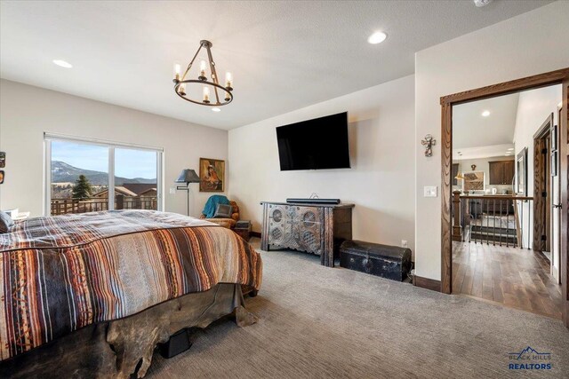 carpeted bedroom featuring recessed lighting, baseboards, and a chandelier