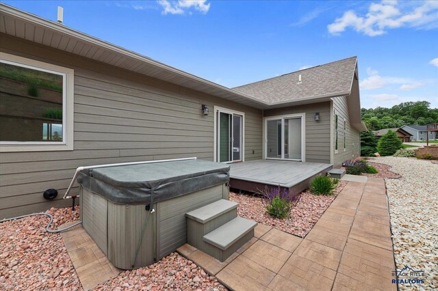 exterior space with a deck and a hot tub