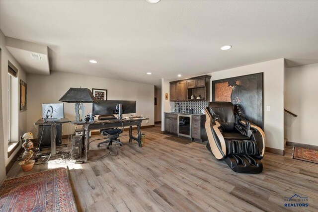 home office with light wood finished floors, visible vents, baseboards, wine cooler, and recessed lighting