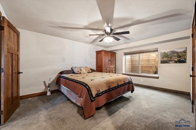 bedroom with carpet flooring, a ceiling fan, baseboards, and a textured ceiling