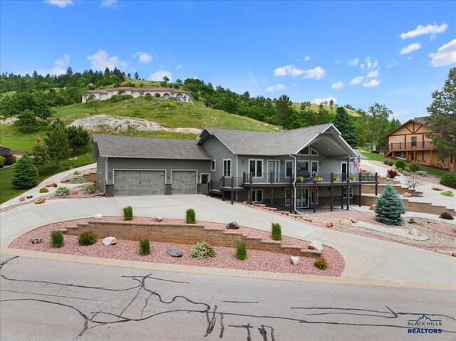 view of front of home featuring a balcony, concrete driveway, and an attached garage